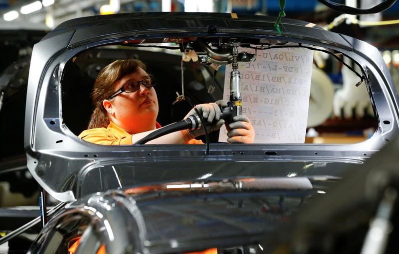 © Reuters. Woman at work at Ford Fiesta assembly line in Cologne