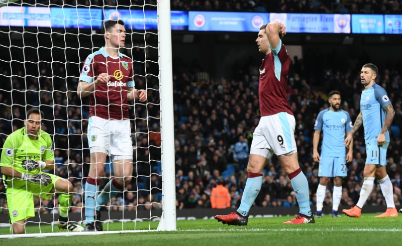 © Reuters. Burnley's Sam Vokes looks dejected as Manchester City's Claudio Bravo  looks on