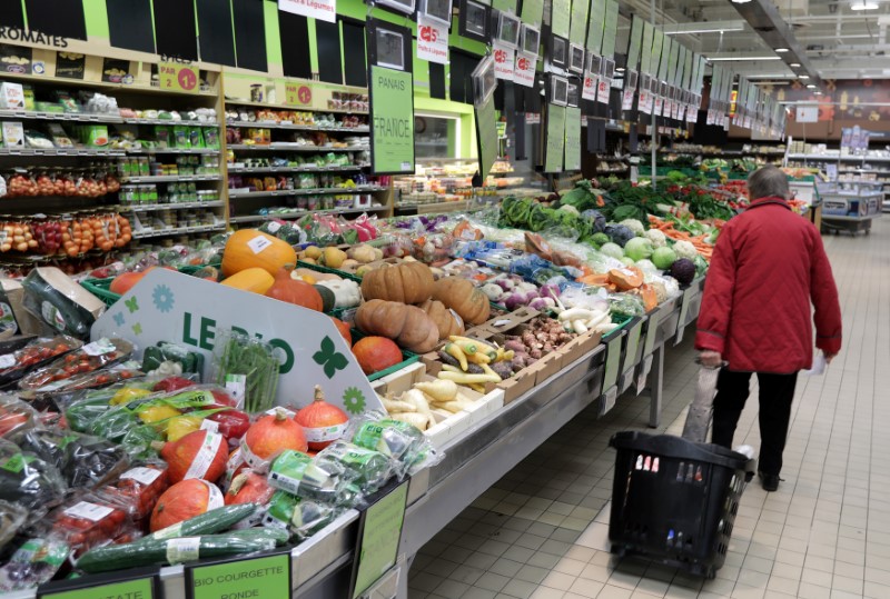 © Reuters. A customer walks past the fruits and vegetables section in a Casino supermarket in Mouans Sartoux