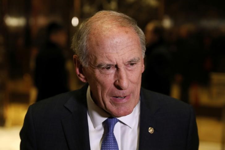 © Reuters. Senator Dan Coats (R-IN) stops to speak to the news media after a meeting at Trump Tower with U.S. President-elect Donald Trump in New York