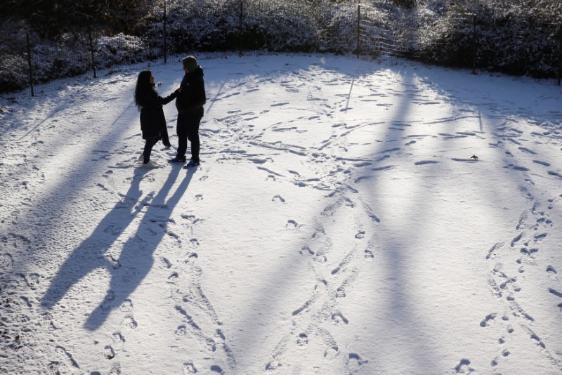 © Reuters. A man and woman stand in a snow covered path at Central Park in New York