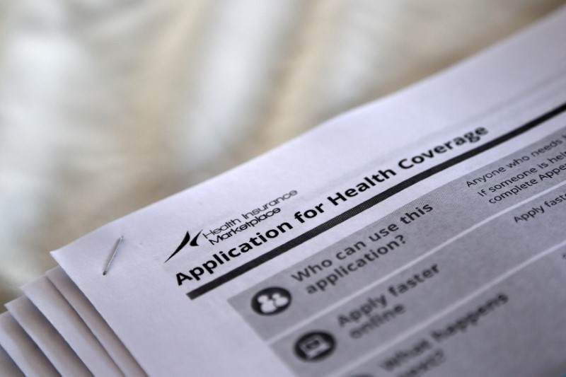 © Reuters. FILE PHOTO - Applications are seen at a rally held by supporters of the Affordable Care Act in Jackson Mississippi