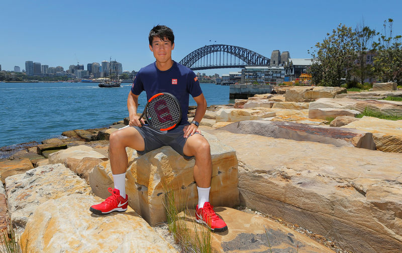 © Reuters. Tennis player Kei Nishikori of Japan poses for the cameras in front of the Sydney Harbour Bridge in Sydney