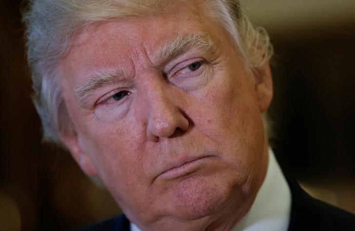 © Reuters. U.S. President-elect Donald Trump listens to questions from reporters in the lobby at Trump Tower in New York