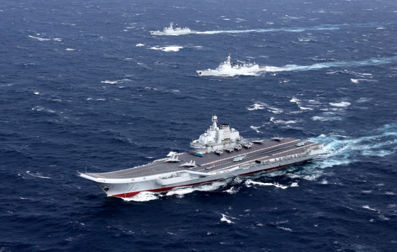 © Reuters. China's Liaoning aircraft carrier with accompanying fleet conducts a drill in an area of South China Sea