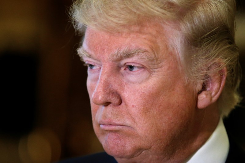 © Reuters. U.S. President-elect Donald Trump listens to questions from reporters in the lobby at Trump Tower in New York