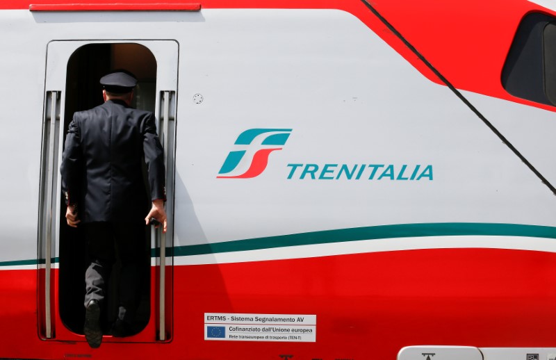 © Reuters. A Trenitalia's conductor goes up on a  Frecciargento's train at the Vatican railway station in Vatican