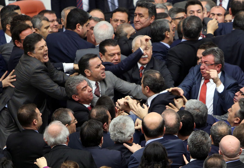 © Reuters. Lawmakers from ruling AK Party and the main opposition Republican People's Party scuffle during a debate on the proposed constitutional changes at the Turkish Parliament in Ankara