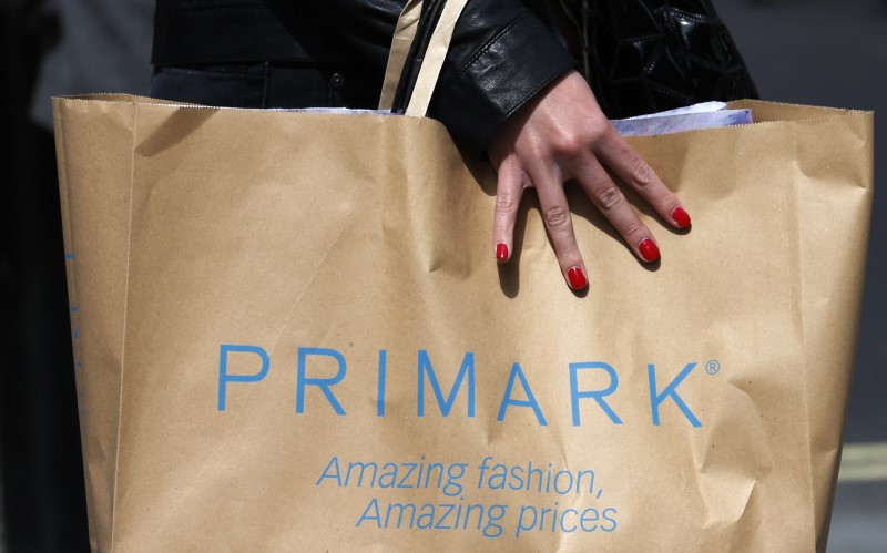© Reuters. File photo of a shopper walking past a branch of clothing retailer Primark in London