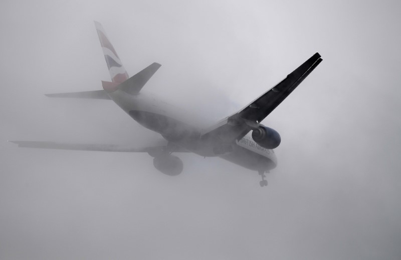 © Reuters. A British Airways passenger aircraft flies through low cloud as it prepares to land at Heathrow airport in west London