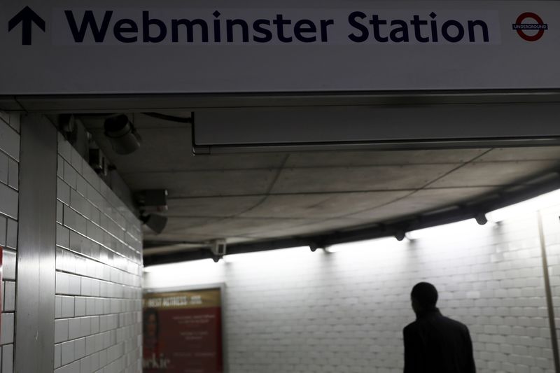 © Reuters. A commuter walks under a tube sign reading 'Webminster' after Amazon rebranded Westminster tube station as a marketing stunt in central London