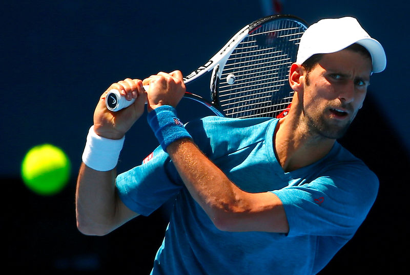 © Reuters. Serbia's Novak Djokovic hits a shot during a training session ahead of the Australian Open tennis tournament in Melbourne, Australia