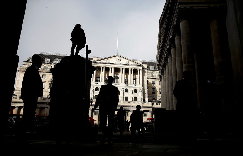 © Reuters. FILE PHOTO: Pedestrians are silhouetted as the winter sun shines on to front of the Bank of England in the City of London