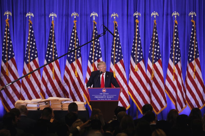 © Reuters. A microphone rises above U.S. President-elect Donald Trump during a news conference in the lobby of Trump Tower in Manhattan, New York City