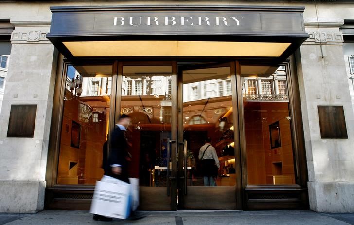 © Reuters. A customer walks in front of a Burberry store in central London