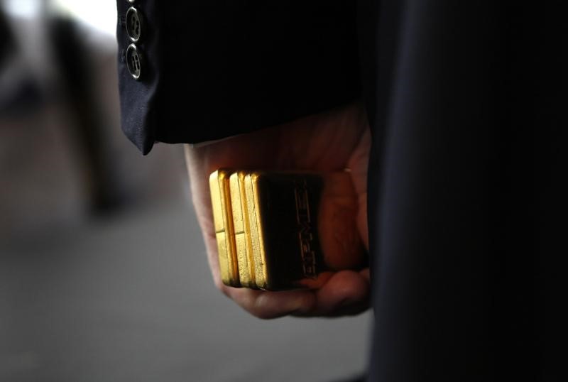 © Reuters. Developer Donald Trump holds Gold Bullion as a security deposit from American Precious Metals Exchange (APMEX) for a 10 year lease for APMEX on the 50th floor of 40 Wall Street in New York