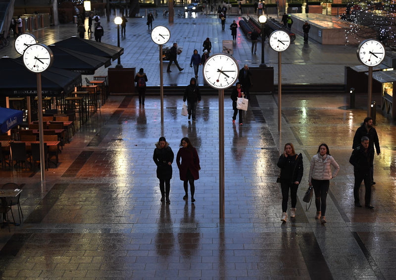 © Reuters. People walk accross a plaza in the Canary Wharf financial district at rush hour during a strike on the Underground by members of two unions in protest at ticket office closures and reduced staffing levels, in London