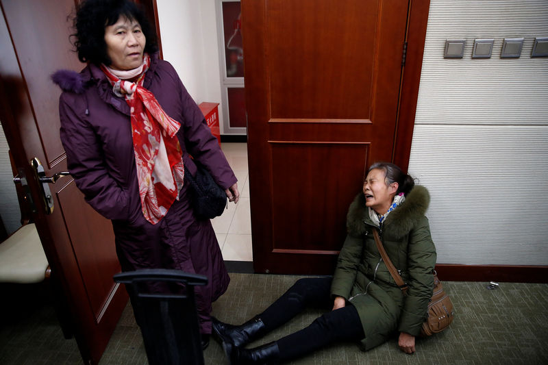 © Reuters. Relatives of passengers onboard Malaysia Airlines flight MH370 which went missing in 2014 react as they arrive for a meeting with the airline representatives in Beijing