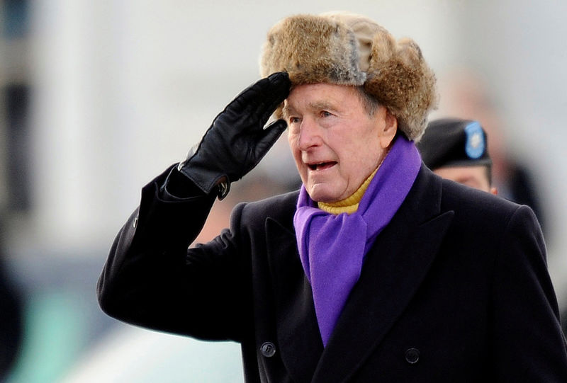 © Reuters. FILE PHOTO - File photo shows former U.S. President George H.W. Bush saluting as he departs the East Front of the U.S. Capitol Building in Washington