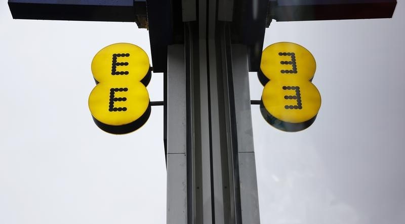 © Reuters. The EE logo is reflected in a window outside an EE shop  in London