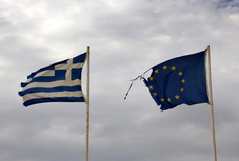 © Reuters. Greek and EU flags flutter at beach in northern Greece