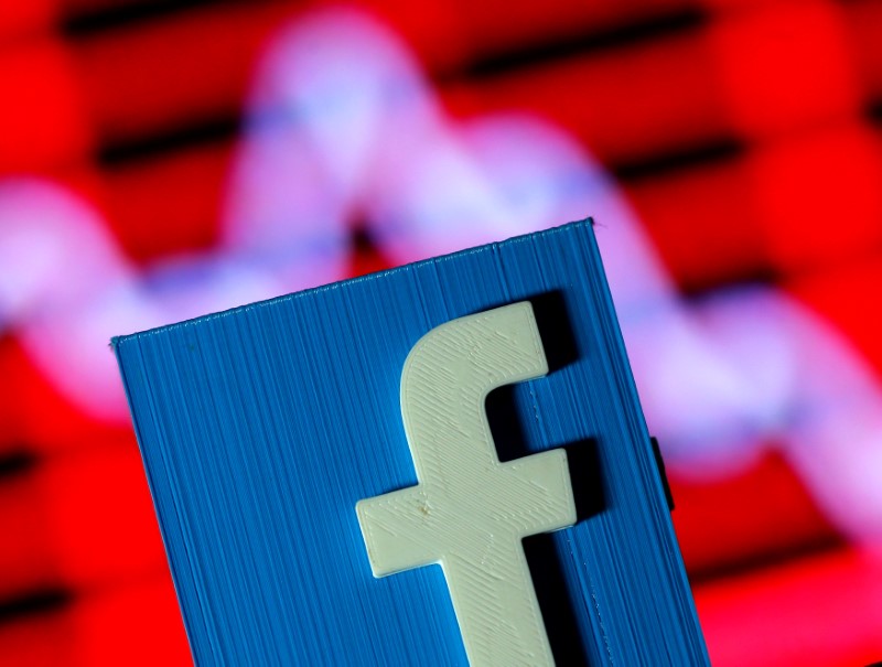 © Reuters. A 3D-printed Facebook logo is seen in front of a displayed stock graph in this illustration taken