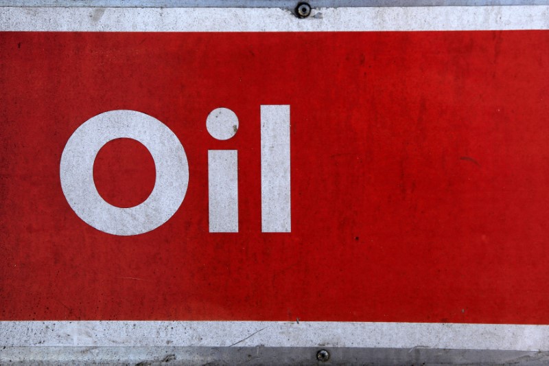 © Reuters. The word oil is pictured on an oil bank at a recycling yard in London
