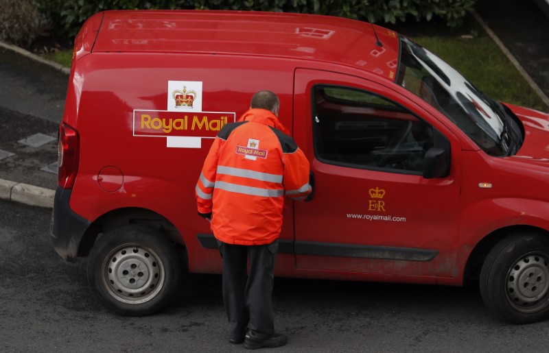 © Reuters. A Royal Mail postal worker returns to his van near Manchester northern England.