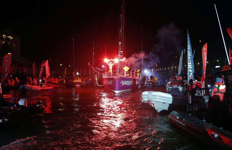 © Reuters. French skipper Armel Le Cleac'h reacts with flares to celebrate his winning the solo round-the-world Vendee Globe sailing race, as he arrives in the port of Les Sables d'Olonne
