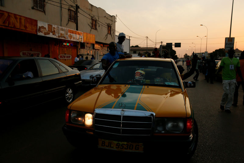 © Reuters. Gambians gather at West field junction to celebrate the swearing-in of Gambia's new President Adama Barrow in Banjul