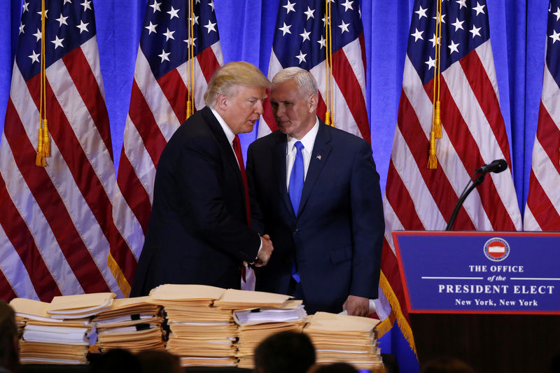 © Reuters. FILE PHOTO - U.S. President-elect Donald Trump greets Vice President-elect Mike Pence during a news conference in Manhattan New York City