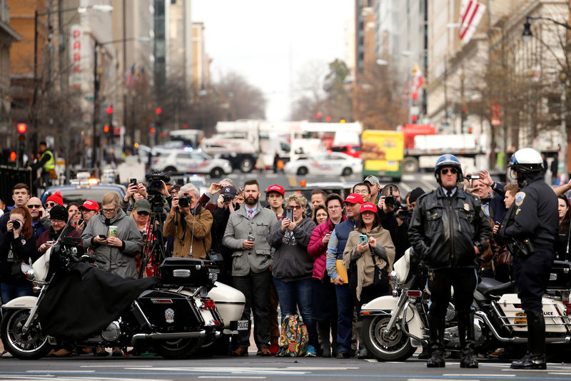 © Reuters. Supporters wait on the street outside as Trump delivers remarks at a luncheon with his cabinet members and congressional leaders inside Trump International Hotel in Washington