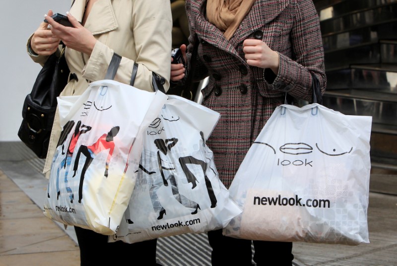 © Reuters. Women hold New Look shopping bags on Oxford Street in London