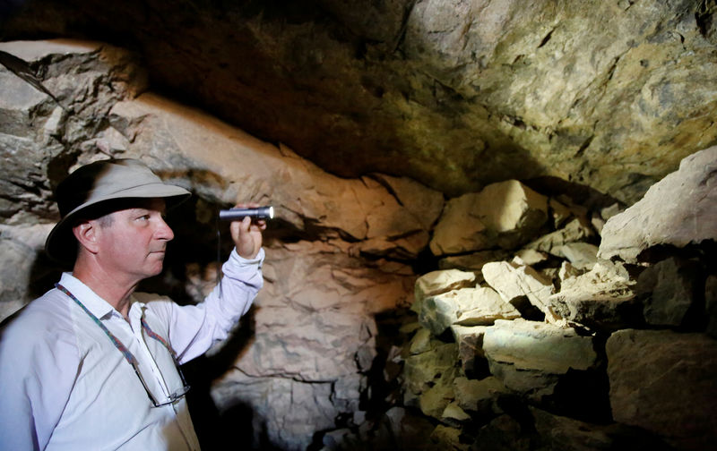 © Reuters. FILE PHOTO: Geologist Leonard Karr uses a flashlight inside an old abandoned mine in the Eastern Desert near the southern province of Luxor