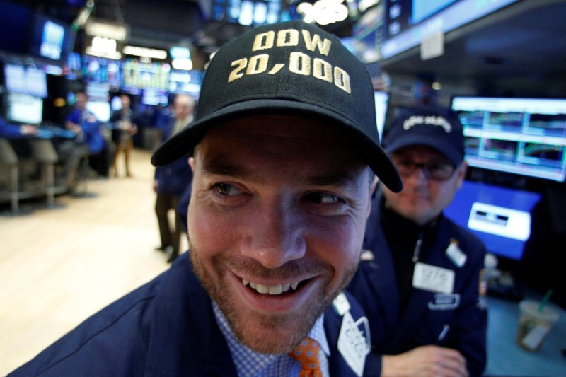 © Reuters. A trader works on the floor of the NYSE as the Dow Jones Industrial Average passes the 20,000 mark in New York