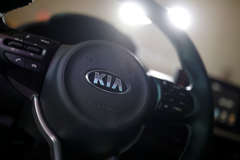 © Reuters. The logo of Kia Motor is seen on a steering wheel of new Morning compact car during its unveiling ceremony in Seoul