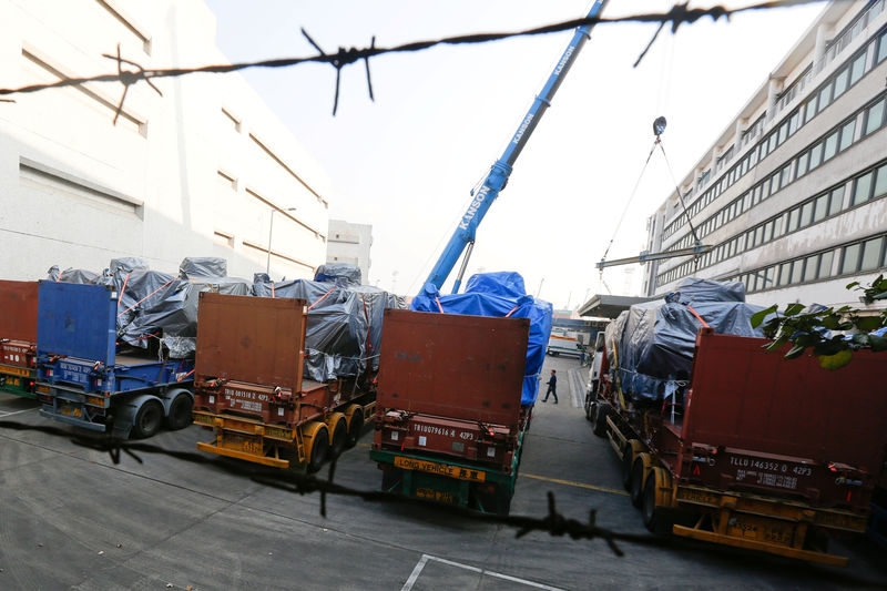 © Reuters. One of nine Terrex armoured vehicles, which belong to Singapore, is loaded onto a truck at a cargo terminal in Hong Kong