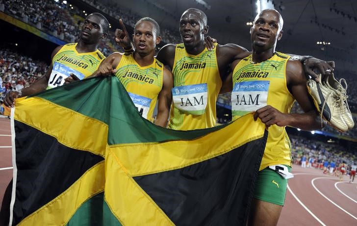 © Reuters. Men's 4x100m relay team of Jamaica celebrate after winning the final at the National Stadium during the Beijing 2008 Olympic Games