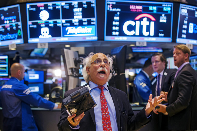 © Reuters. FILE PHOTO: Trader Tuchman gestures as he talks on the phone following the resumption of trading following a several hour long stoppage on the floor of the New York Stock Exchange