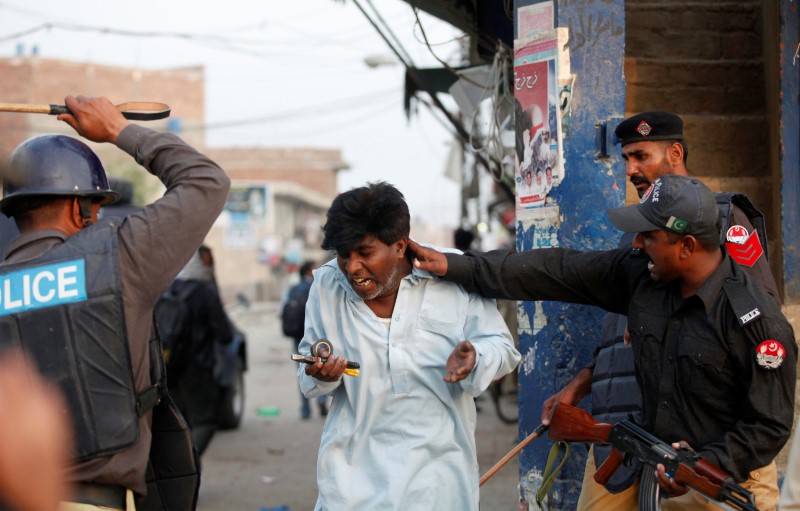© Reuters. FILE PHOTO: Police beat and detain a Pakistani Christian protester during a demonstration in Badami Bagh