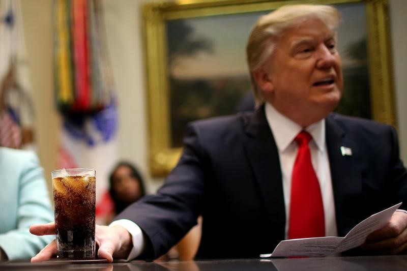 © Reuters. U.S. President Donald Trump holds a beverage as he attends a breakfast meeting with small business leaders hosted by Trump at the Roosevelt room of the White House in Washington U.S.