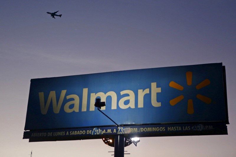 © Reuters. Aircraft flies over a Wal-Mart billboard in Mexico City