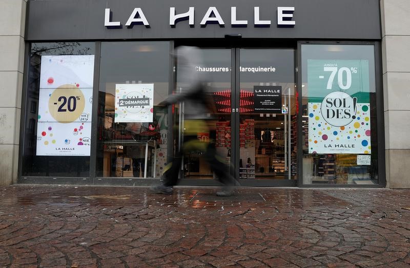 © Reuters. People walk past a shoes store of the brand 