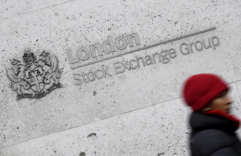 © Reuters. A woman walks past the London Stock Exchange building in the City of London, Britain