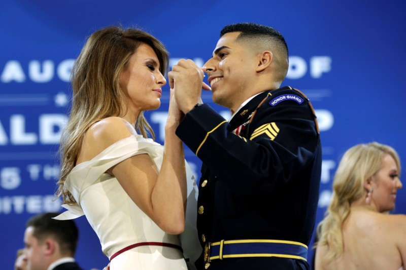 © Reuters. US first lady Melania Trump dances with army services member