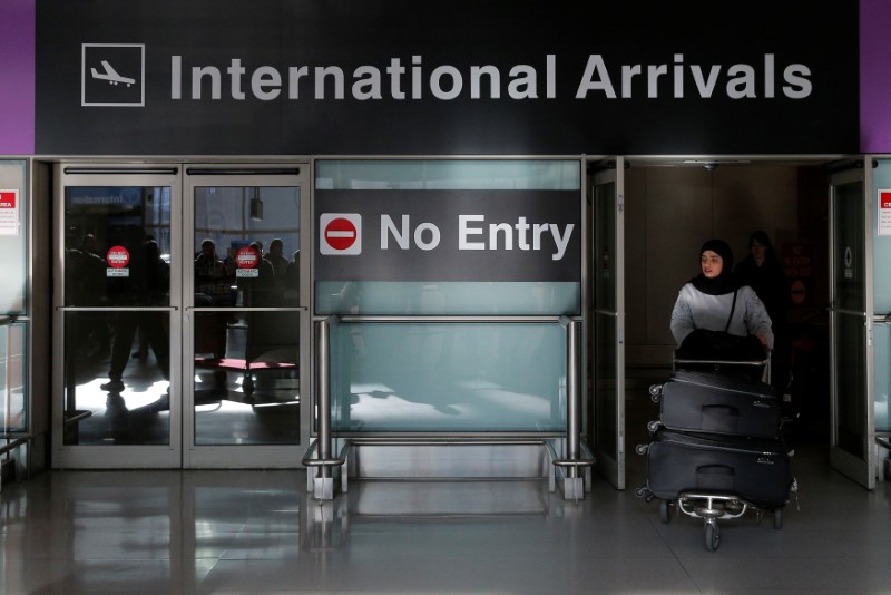 © Reuters. An international traveler arrives after U.S. President Donald Trump's executive order travel ban at Logan Airport in Boston