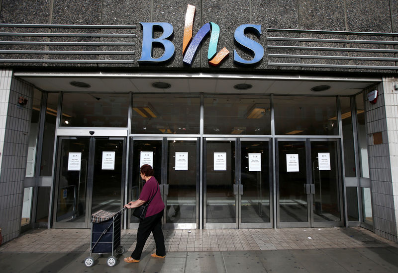 © Reuters. FILE PHOTO: A woman walks past the Wood Green branch of department store chain BHS after its final closure in London