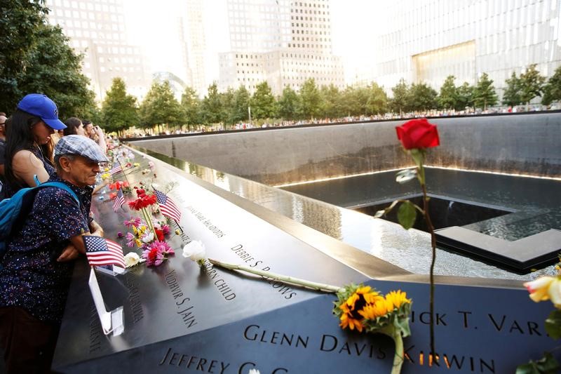 © Reuters. FILE PHOTO: Visitors look out over the National September 11 Memorial and Museum on the 15th anniversary of the 9/11 attacks in New York