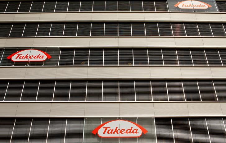 © Reuters. FILE PHOTO - Logos of Japanese Takeda Pharmaceutical Co are seen at an office building in Glattbrugg