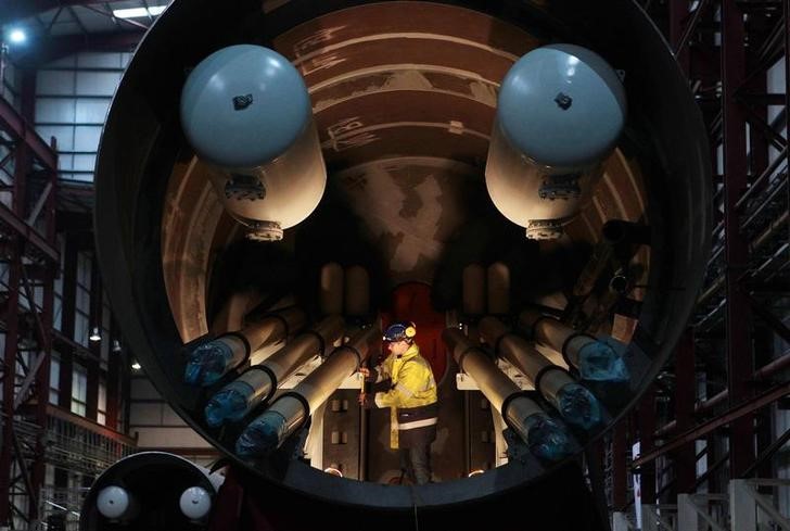 © Reuters. An engineer works inside a section of a Pelamis wave machine at their factory in Edinburgh, Scotland